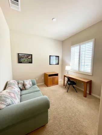 a bedroom with furniture and a window