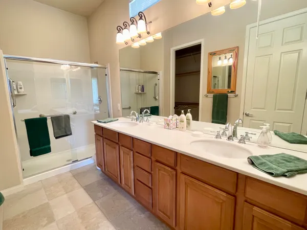 a spacious bathroom with a double vanity sink a and a mirror