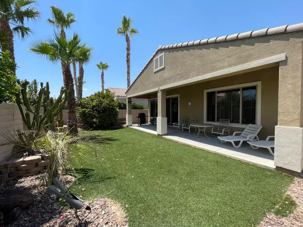 a front view of house with yard and outdoor seating