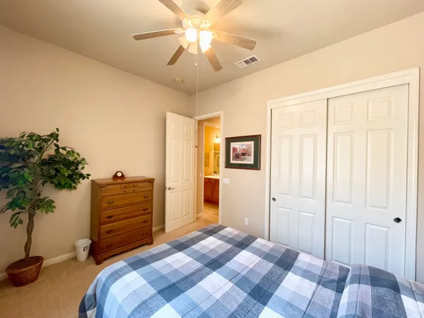 a bedroom with a bed and a potted plant