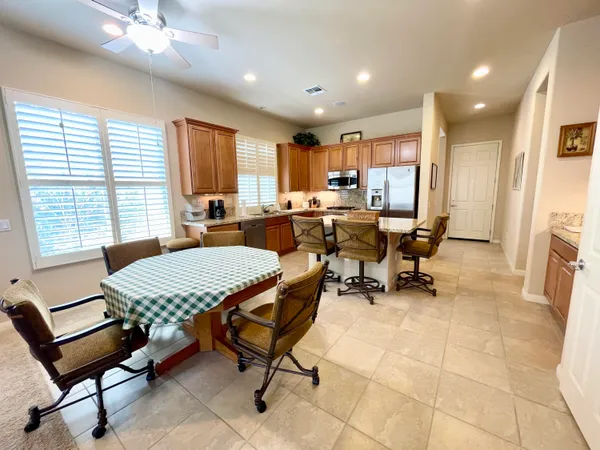 a outdoor dining space with furniture and a kitchen