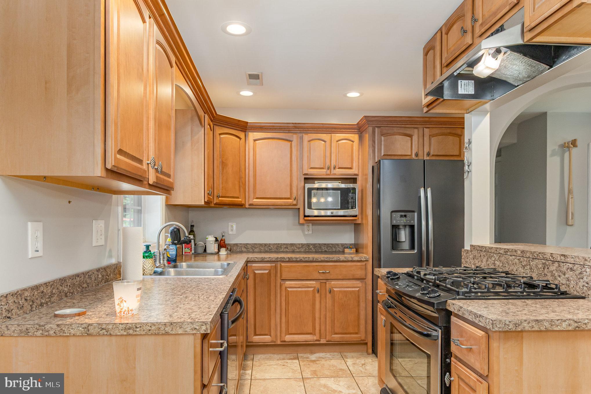 2204 Blevins Road Edgewood, MD 21040 - Photo 12 of 28 a kitchen with stainless steel appliances granite countertop a sink stove and refrigerator