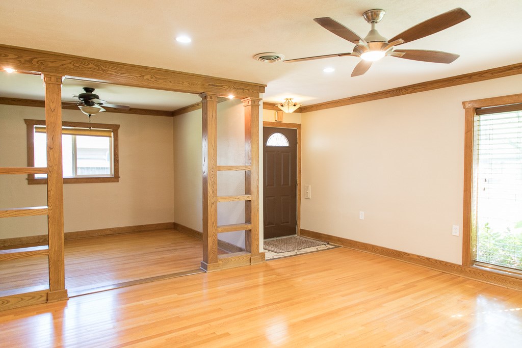 9010 Linkmeadow Lane Houston, TX 77025 - Photo 13 of 39 a view of an empty room with wooden floor and a ceiling fan
