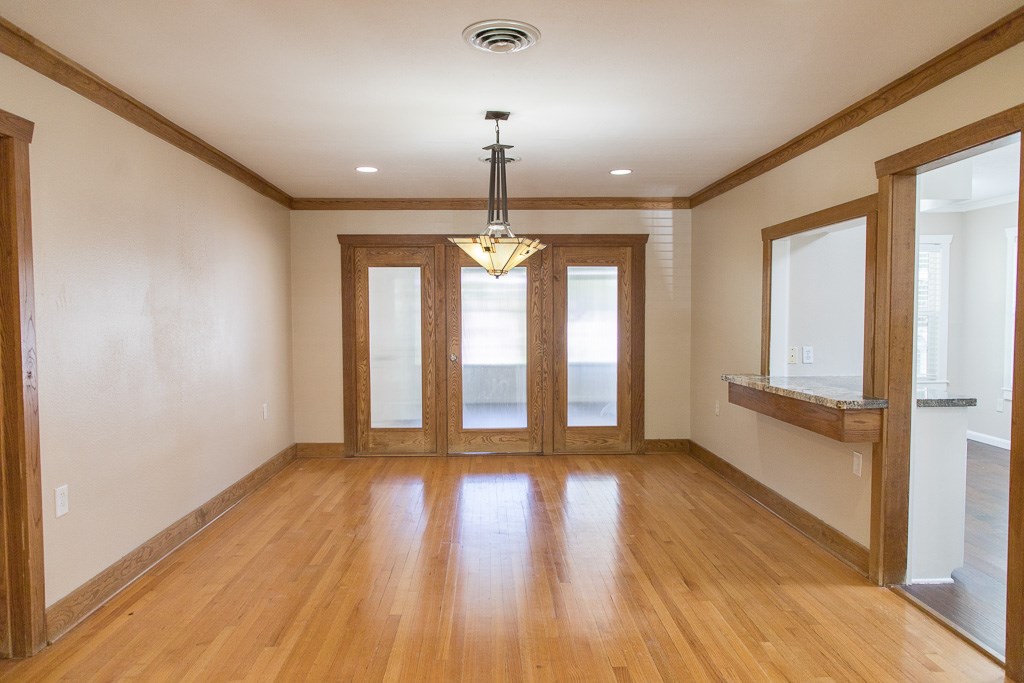 9010 Linkmeadow Lane Houston, TX 77025 - Photo 19 of 39 a view of an empty room with wooden floor and a window