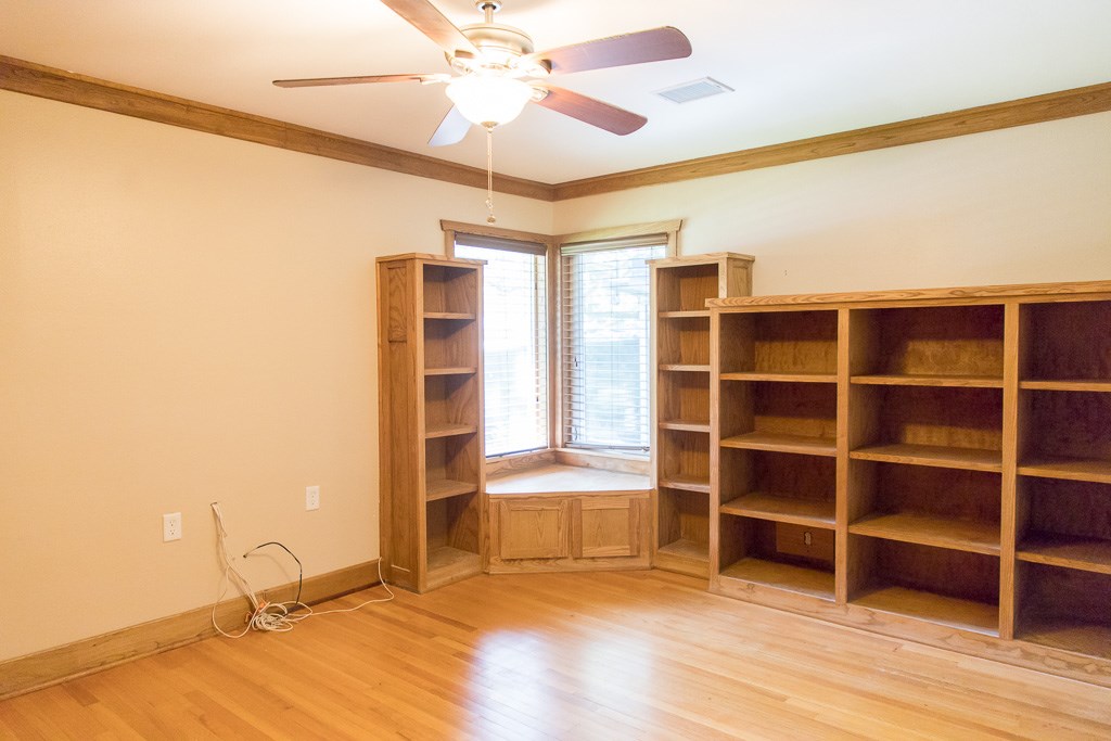 9010 Linkmeadow Lane Houston, TX 77025 - Photo 25 of 39 a view of a livingroom with wooden floor and a ceiling fan