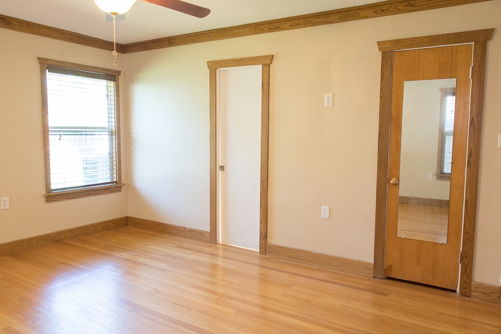 9010 Linkmeadow Lane Houston, TX 77025 - Photo 30 of 39 an empty room with wooden floor and a window