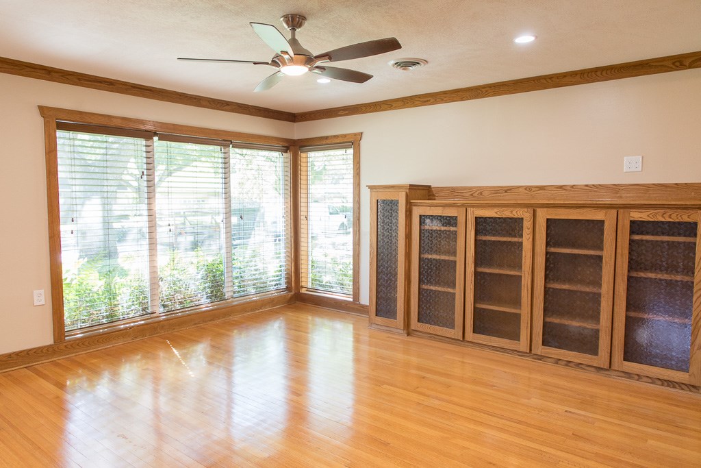 9010 Linkmeadow Lane Houston, TX 77025 - Photo 4 of 39 a view of an empty room with a window and wooden floor