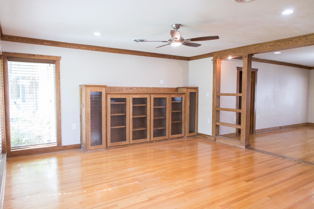 9010 Linkmeadow Lane Houston, TX 77025 - Photo 9 of 39 a view of an empty room with wooden floor and a window