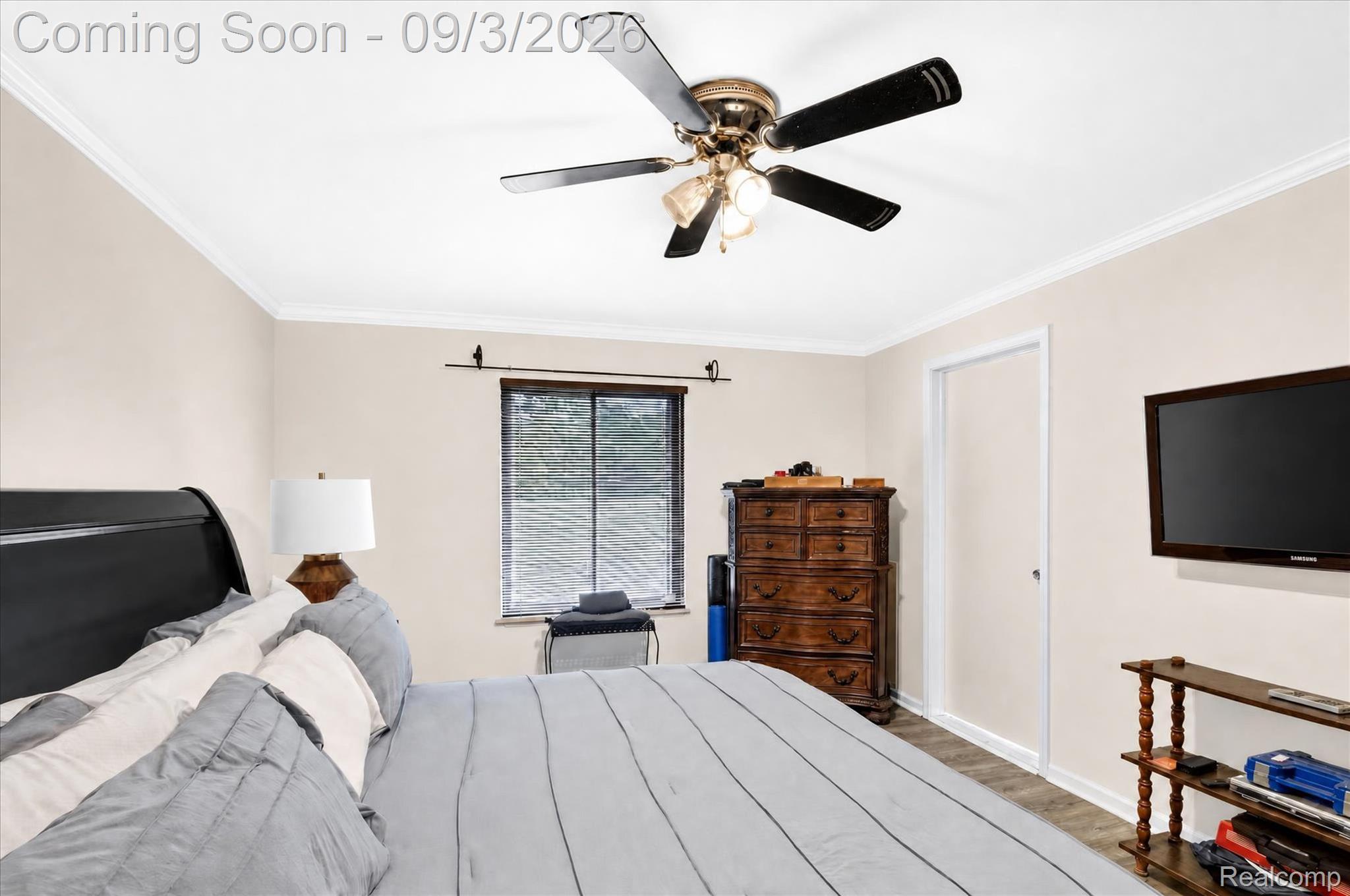 27260 Campbell Road Warren, MI 48093 - Photo 21 of 60 Ceiling fan with light fixture, window with blinds, wood-finish flooring, and white trim