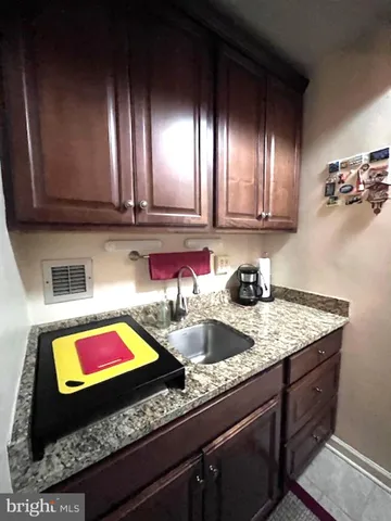 a kitchen with sink and cabinets