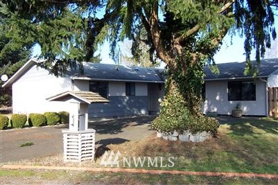 18244 Cinnamon Lane Southwest Rochester, WA 98579 - Photo 1 of 1 a front view of a house with garden