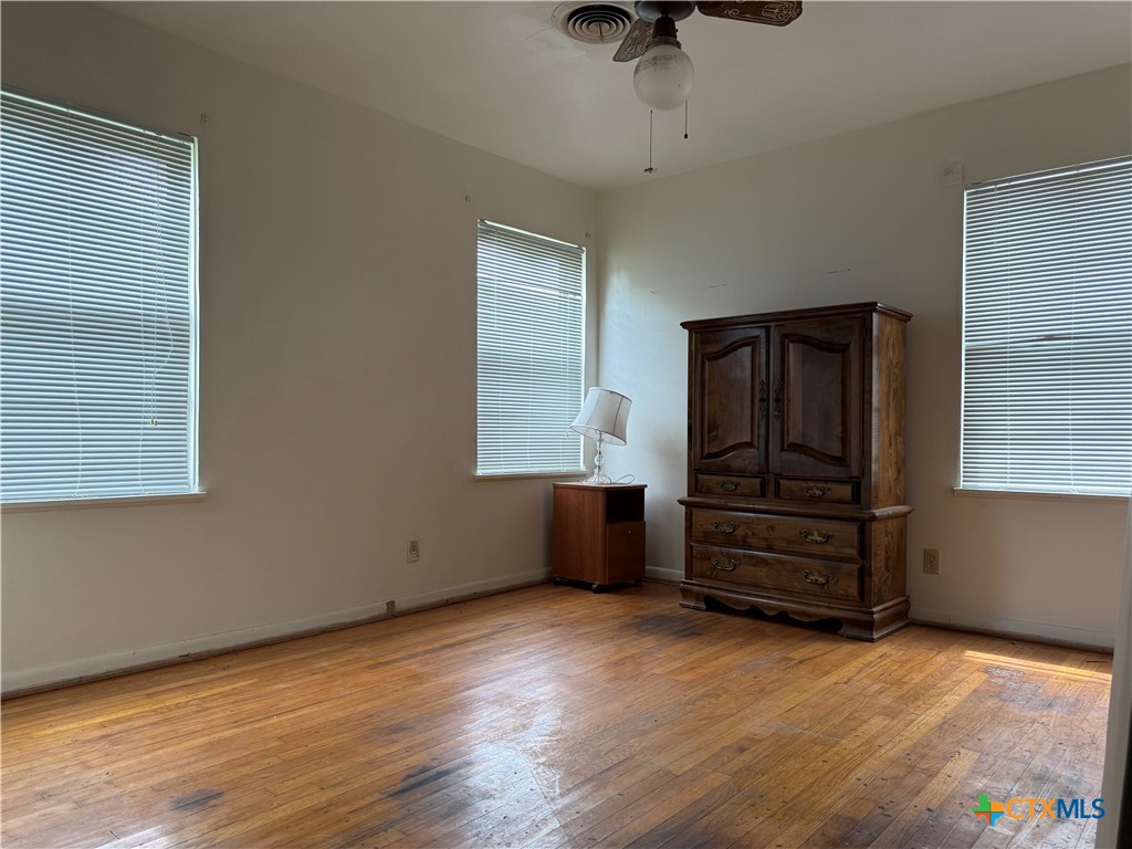 411 Cardinal Avenue Killeen, TX 76541 - Photo 14 of 14 wooden floor and window in an empty room