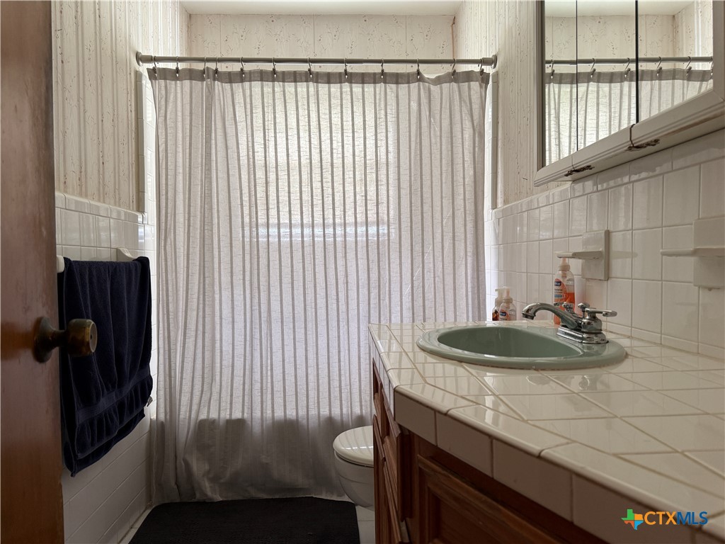 411 Cardinal Avenue Killeen, TX 76541 - Photo 9 of 14 a bathroom with a sink and a mirror