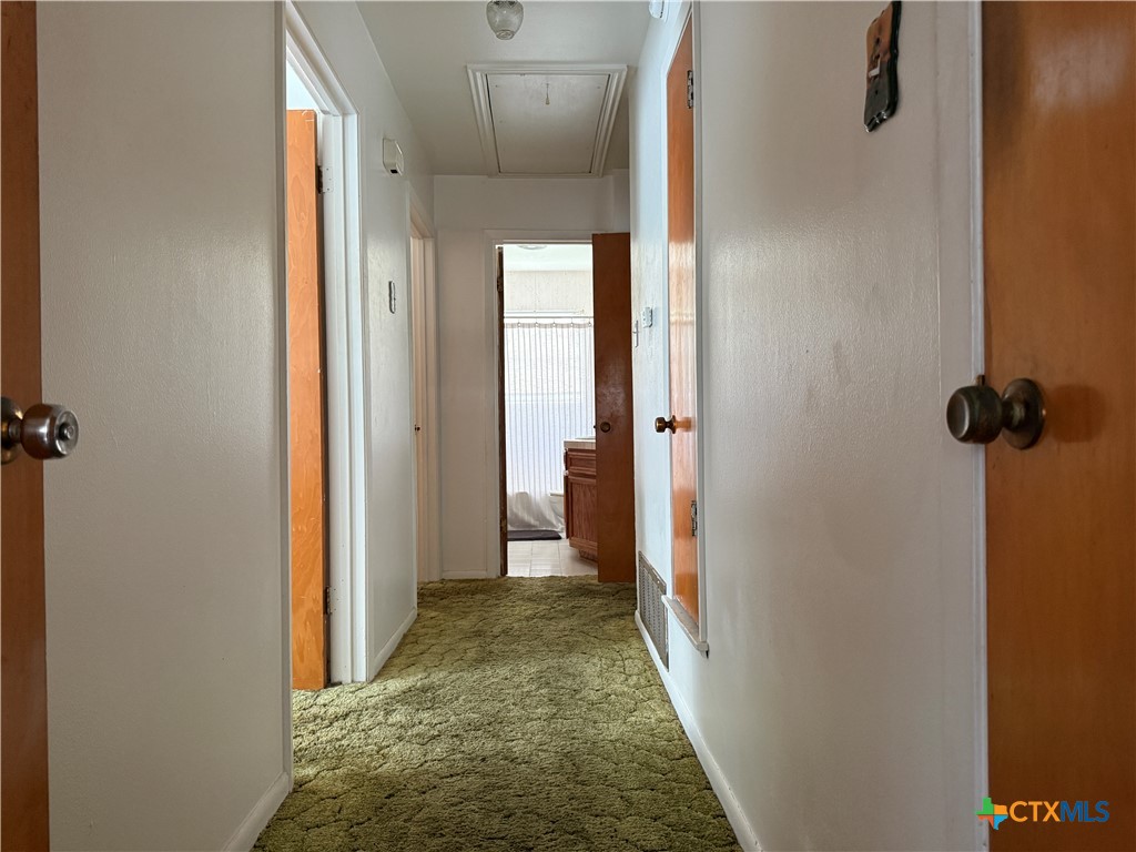 411 Cardinal Avenue Killeen, TX 76541 - Photo 10 of 14 a view of a hallway with wooden floor and a bathroom