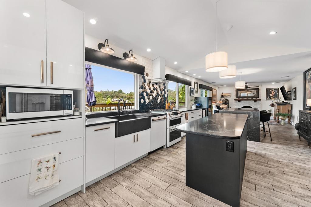 a kitchen with stainless steel appliances kitchen island granite countertop a stove and cabinets