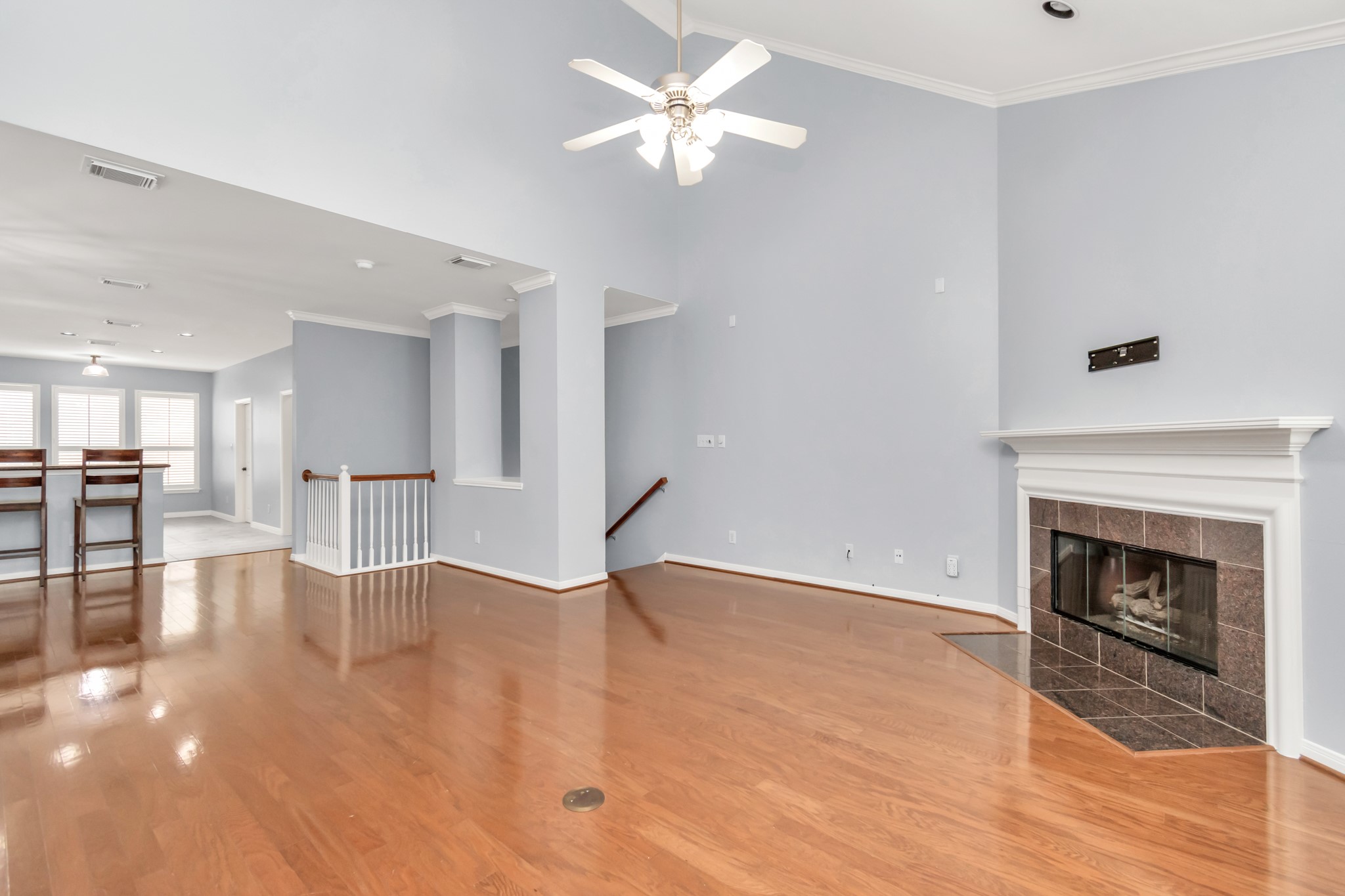2901 West Dallas Street Houston, TX 77019 - Photo 13 of 39 a view of a livingroom with a fireplace a chandelier fan and wooden floor