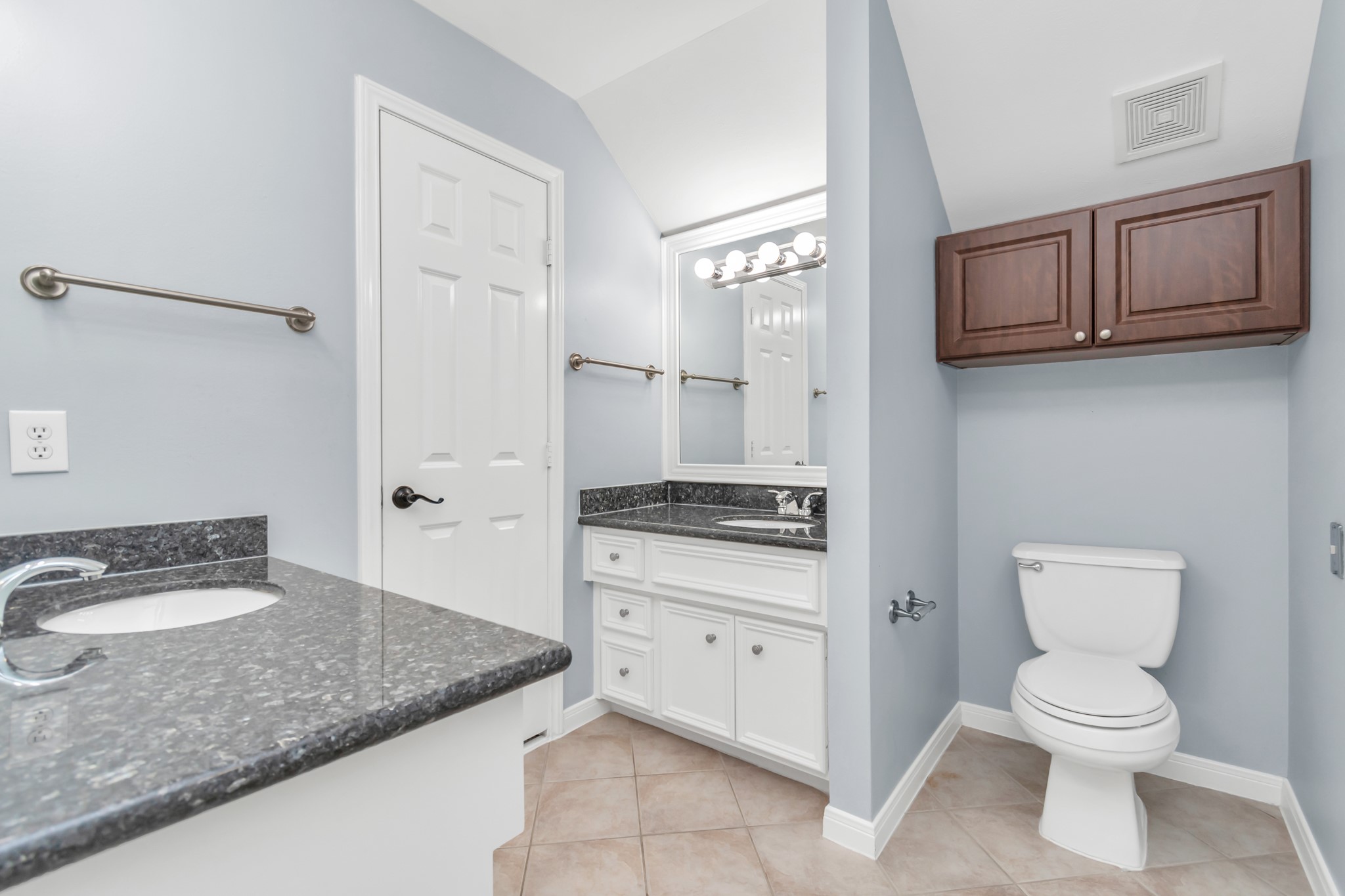2901 West Dallas Street Houston, TX 77019 - Photo 32 of 39 a bathroom with a granite countertop sink a toilet and a mirror
