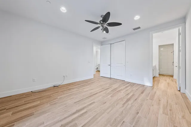 a view of an empty room and wooden floor