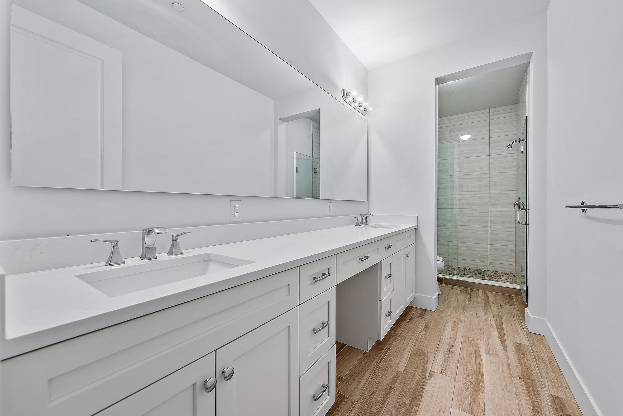 3770 County Line Road, Unit C4 Tequesta, FL 33469 - Photo 20 of 29 a spacious bathroom with a double vanity sink and mirror