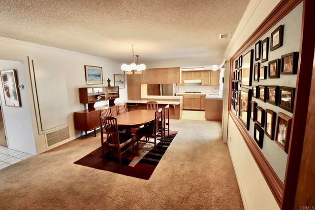 a living room with furniture a flat screen tv and a table