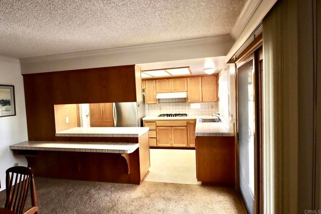 a kitchen with a refrigerator and a window