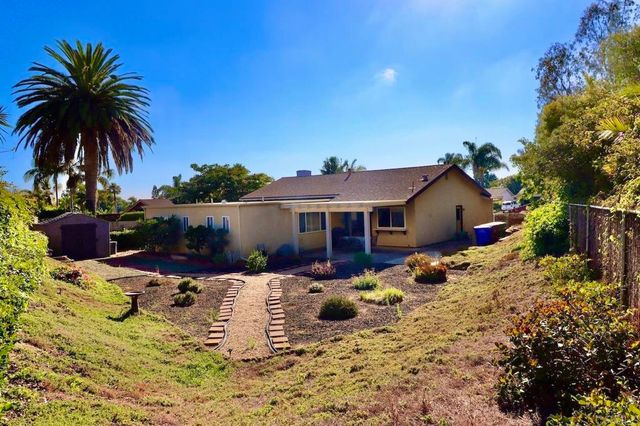 a aerial view of a house with swimming pool and sitting area