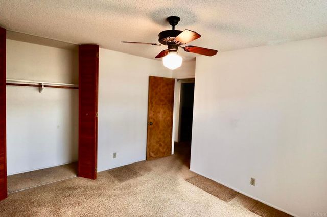 a view of a room with a ceiling fan