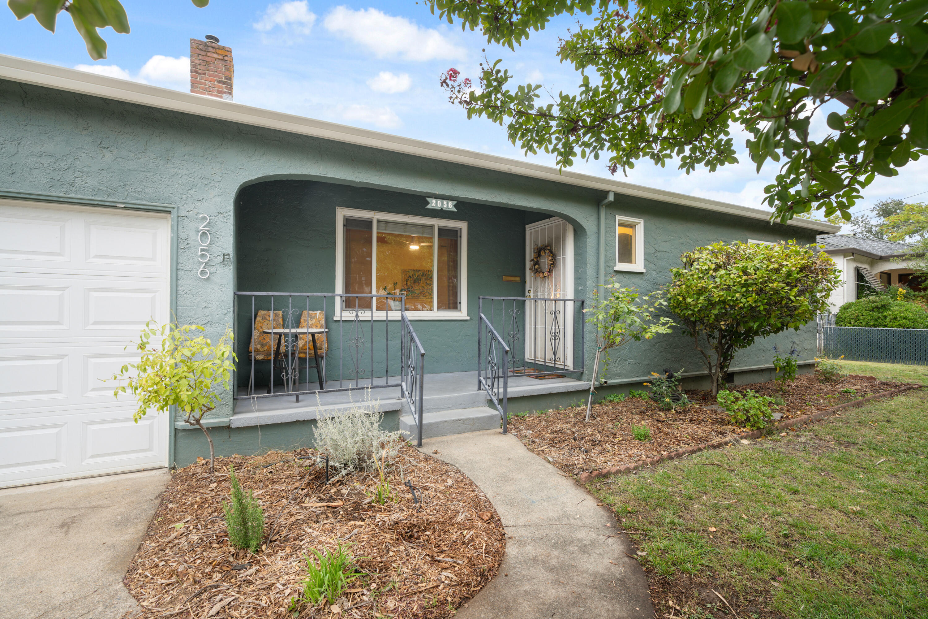 a front view of a house with garden