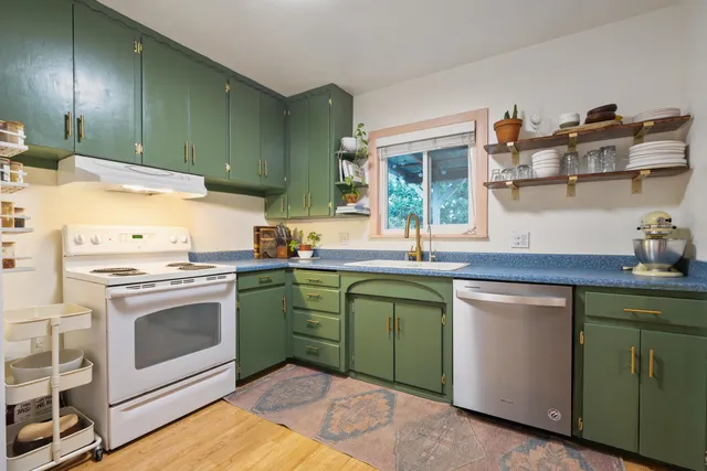 a kitchen with cabinets a sink and appliances