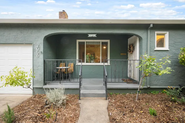 a front view of a house with garden
