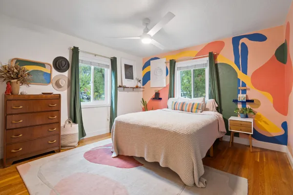 a bedroom with a bed and wooden floor