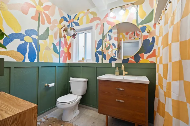 a bathroom with a toilet sink and mirror