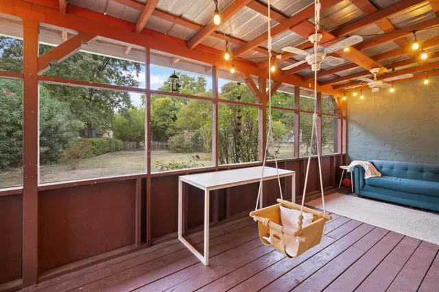 a view of a living room with furniture and wooden floor
