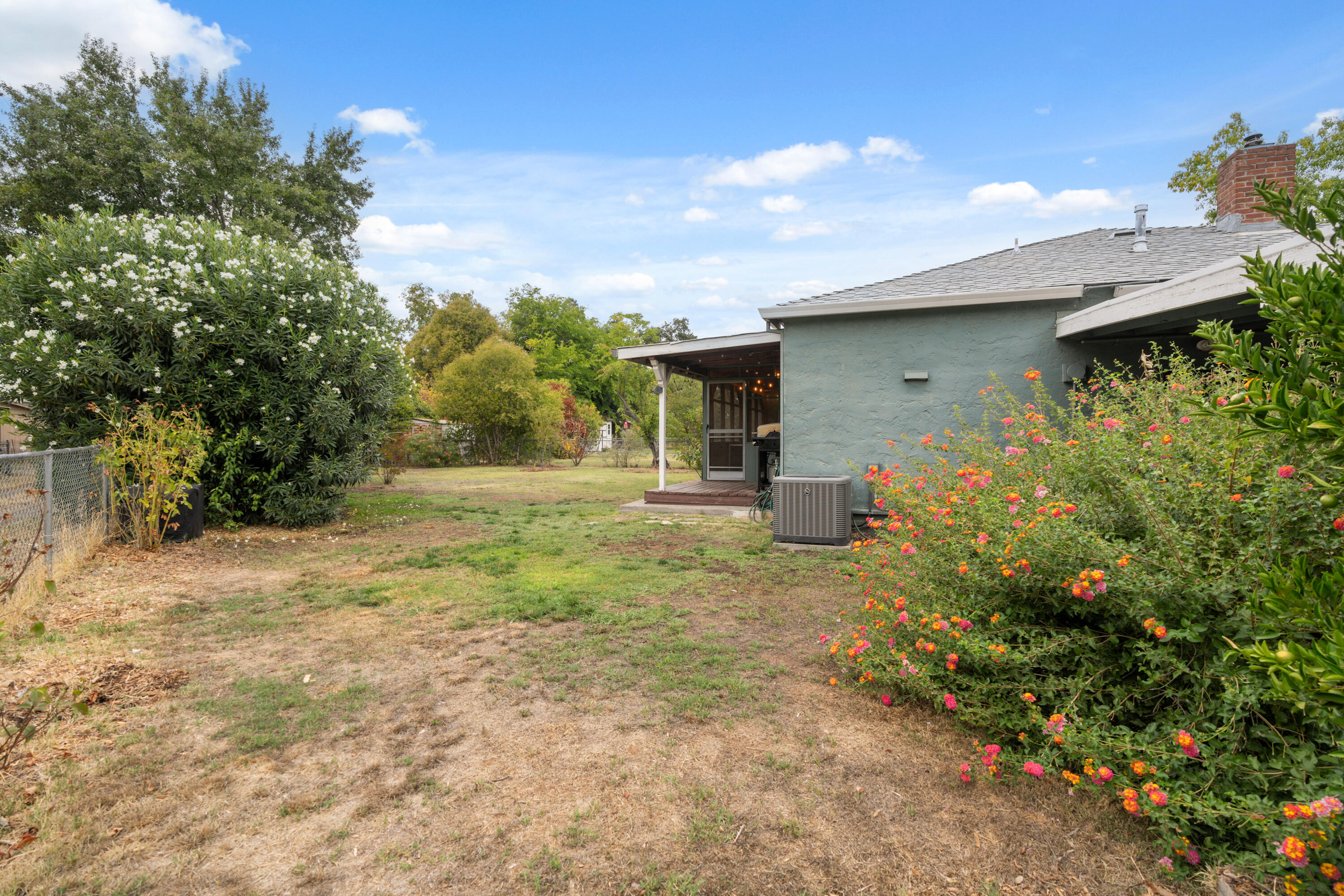 2056 Canal Drive Redding, CA 96001 - Photo 30 of 46 a backyard of a house with lots of green space