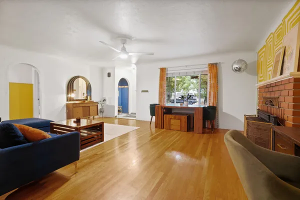 a living room with fireplace furniture and a window