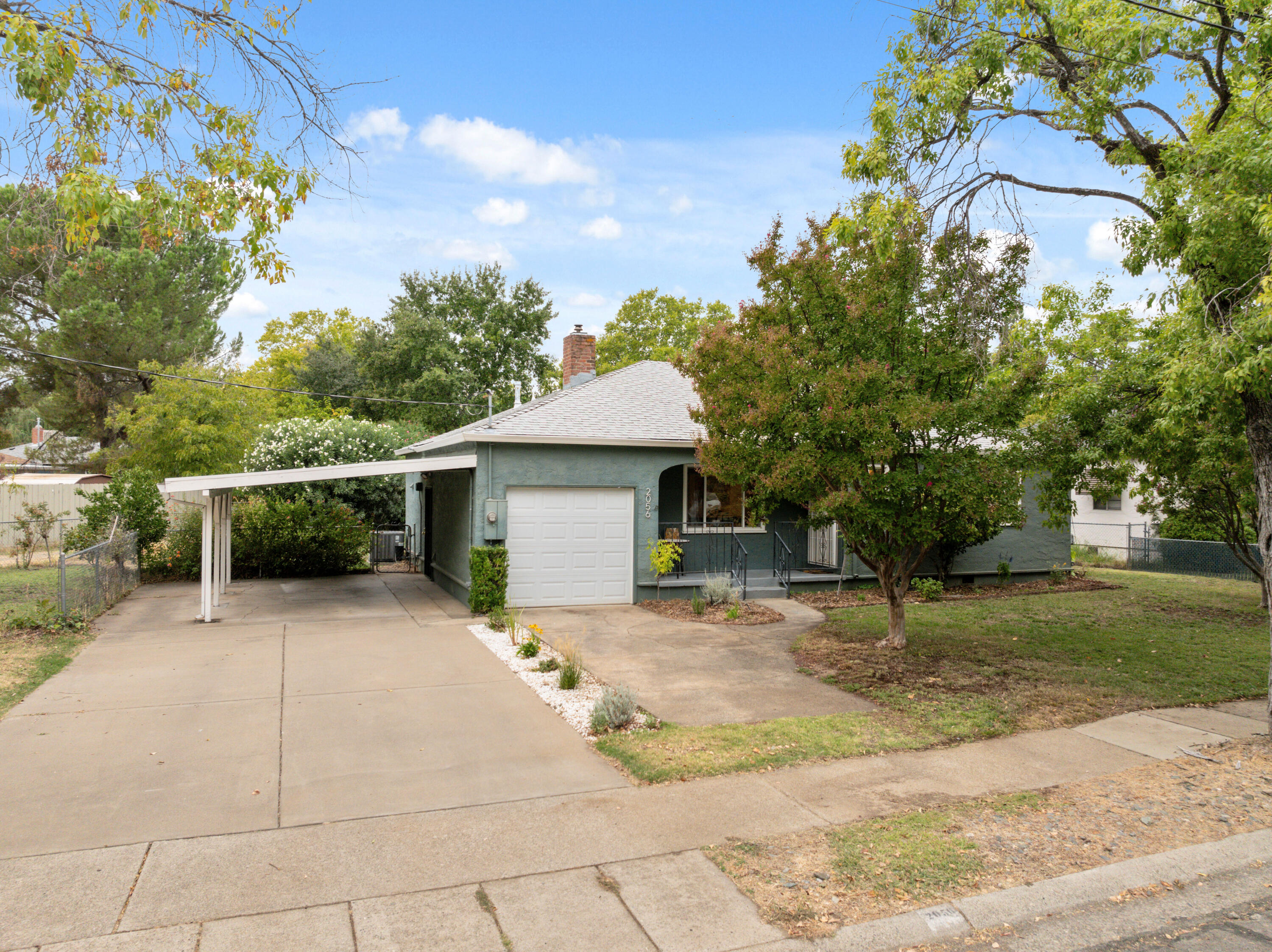 2056 Canal Drive Redding, CA 96001 - Photo 41 of 46 a backyard of a house with table and chairs under an umbrella