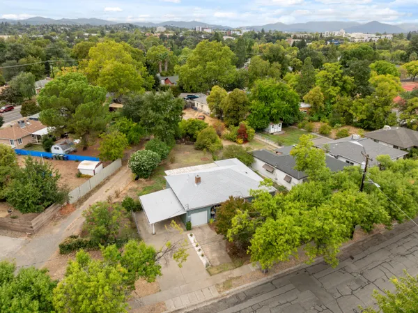 an aerial view of a house with a yard