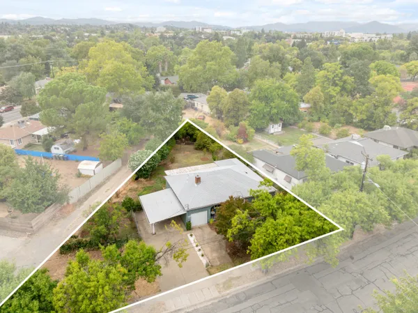 an aerial view of residential houses with outdoor space