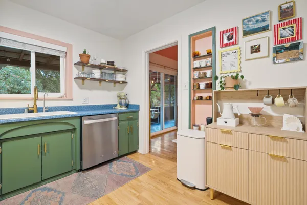 a room with a sink cabinets and window