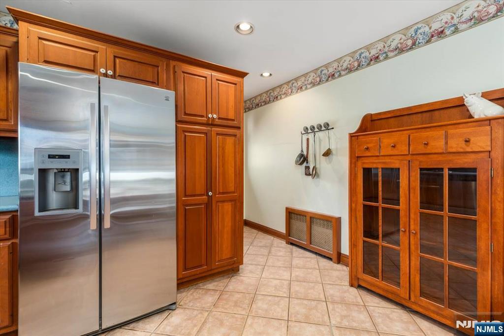 618 3rd Avenue Lyndhurst, NJ 07071 - Photo 12 of 33 a view of a refrigerator in kitchen and an empty room with wooden floor