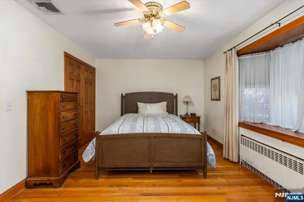 a bedroom with a bed chair and a window