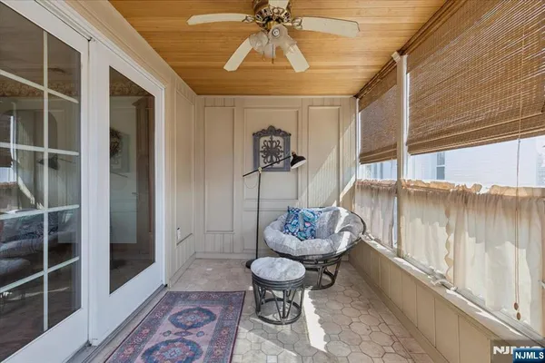 a living room with furniture and a ceiling fan