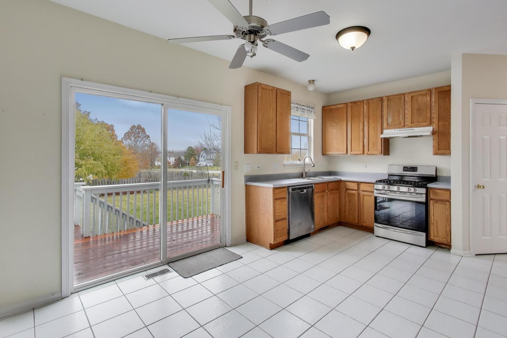 697 Providence Lane Lindenhurst, IL 60046 - Photo 11 of 31 a kitchen with stainless steel appliances granite countertop a stove a sink and a refrigerator