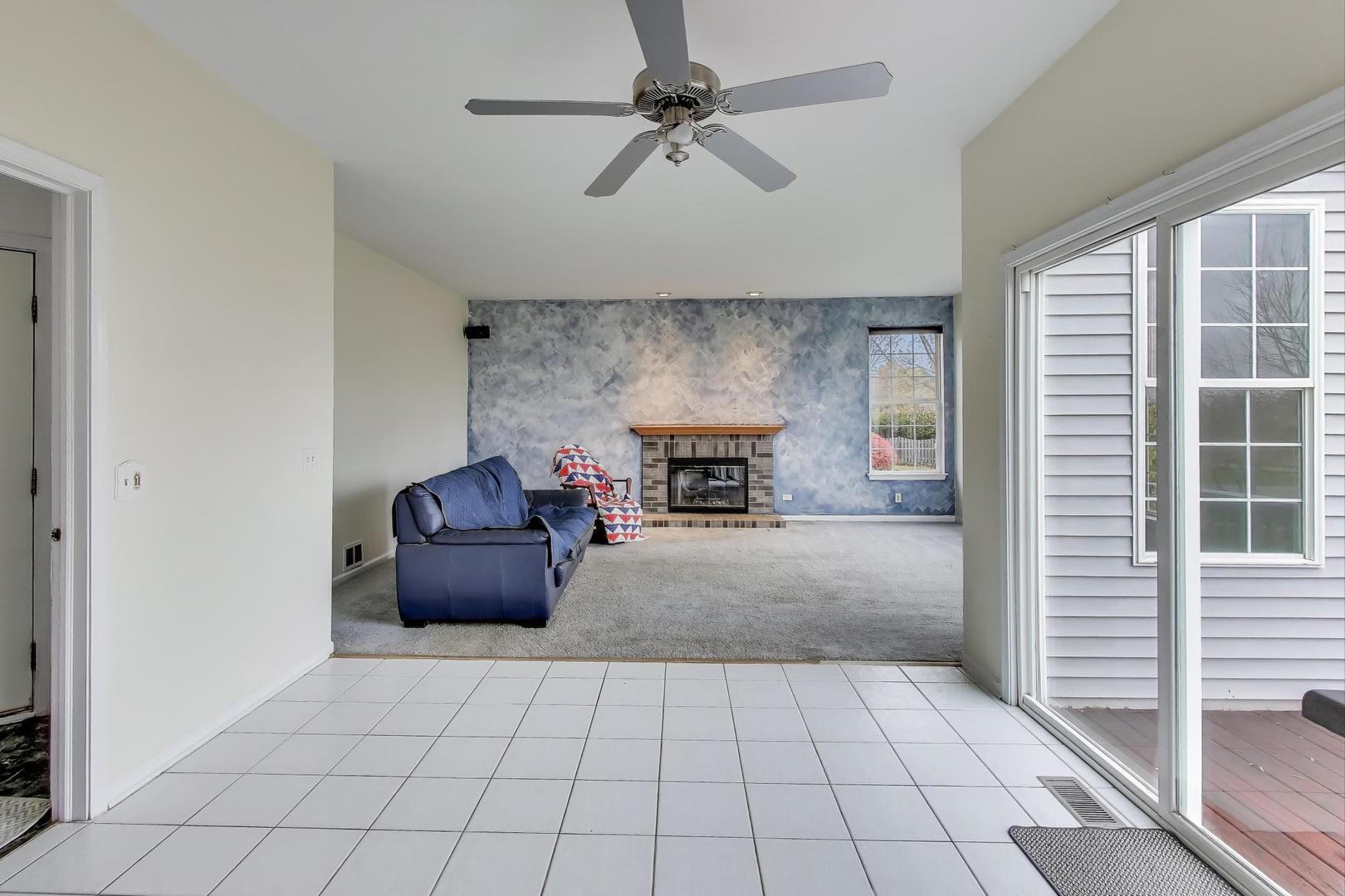 697 Providence Lane Lindenhurst, IL 60046 - Photo 12 of 31 a living room with furniture and a fireplace