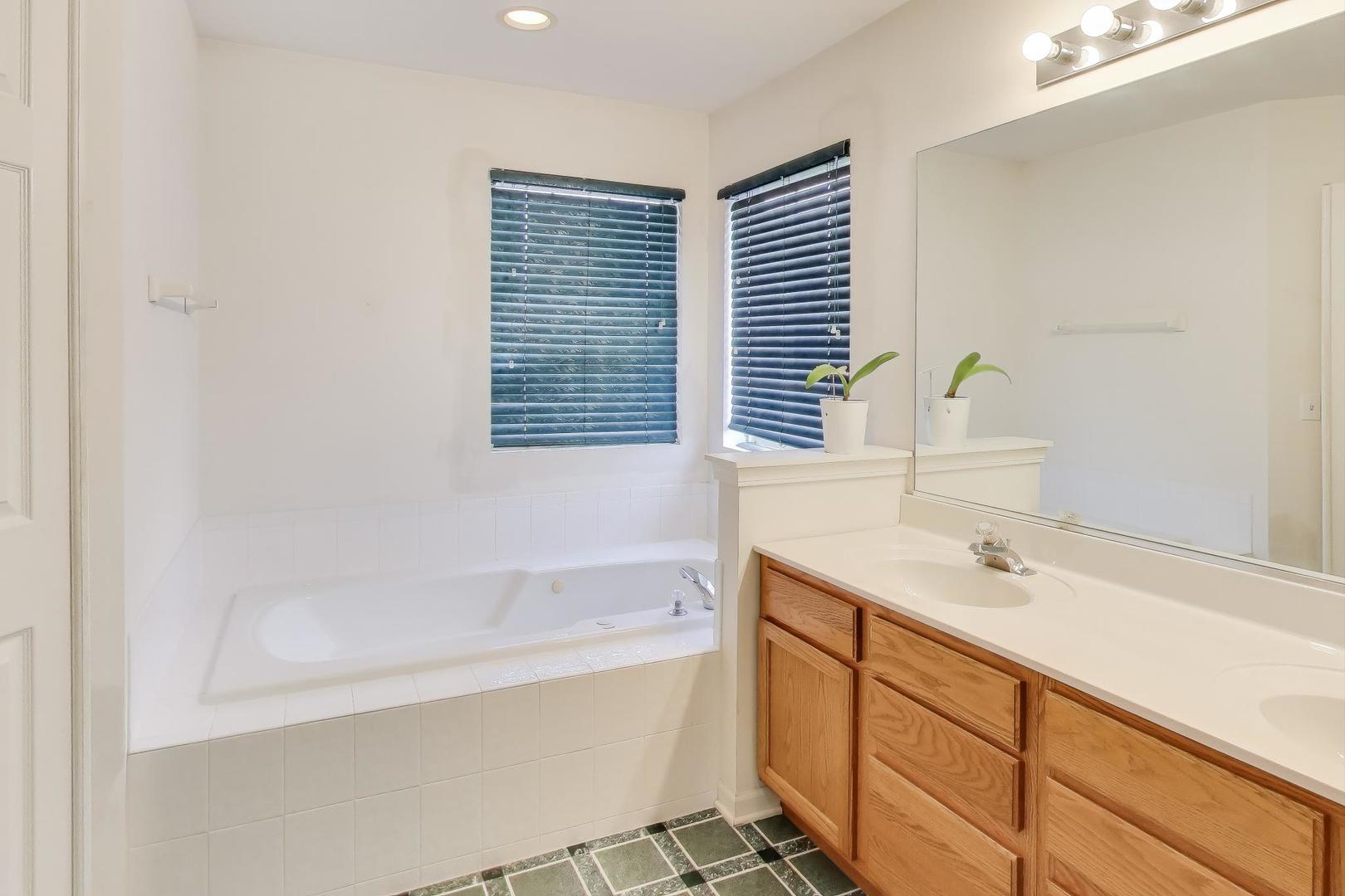 697 Providence Lane Lindenhurst, IL 60046 - Photo 17 of 31 a bathroom with a sink and a bathtub