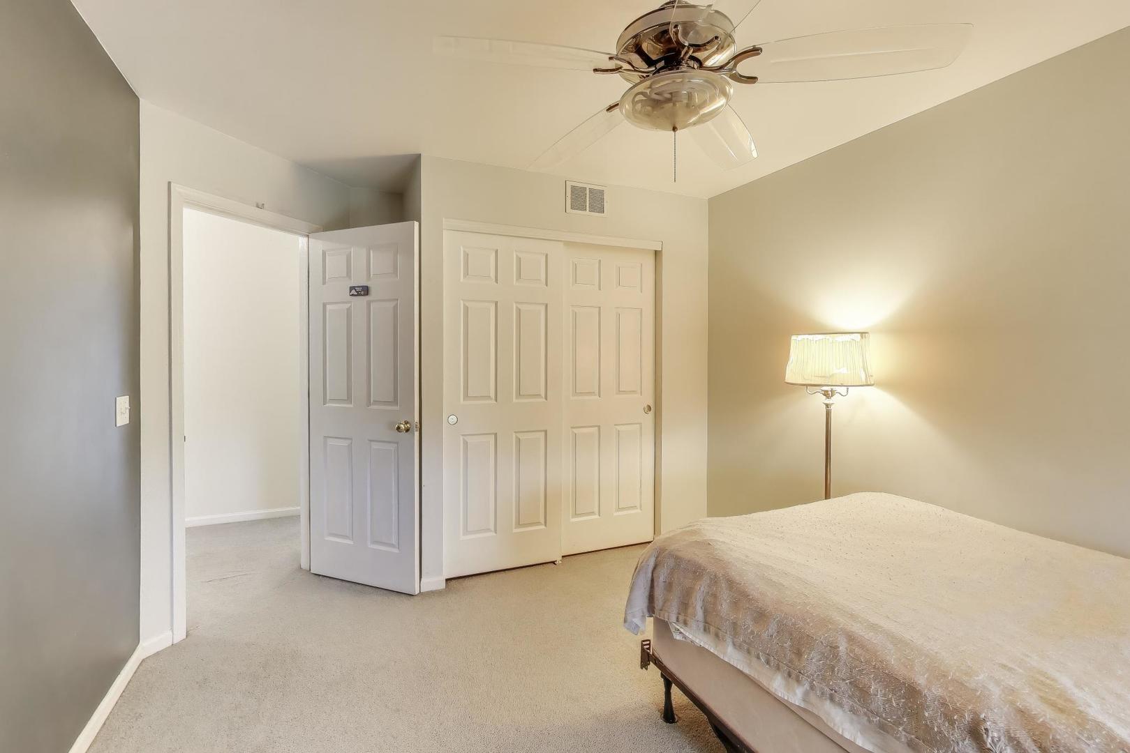 697 Providence Lane Lindenhurst, IL 60046 - Photo 20 of 31 a spacious bedroom with a bed and a chandelier