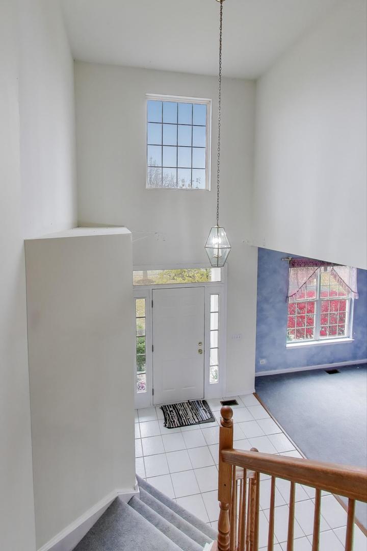 697 Providence Lane Lindenhurst, IL 60046 - Photo 4 of 31 a bedroom with furniture and a window