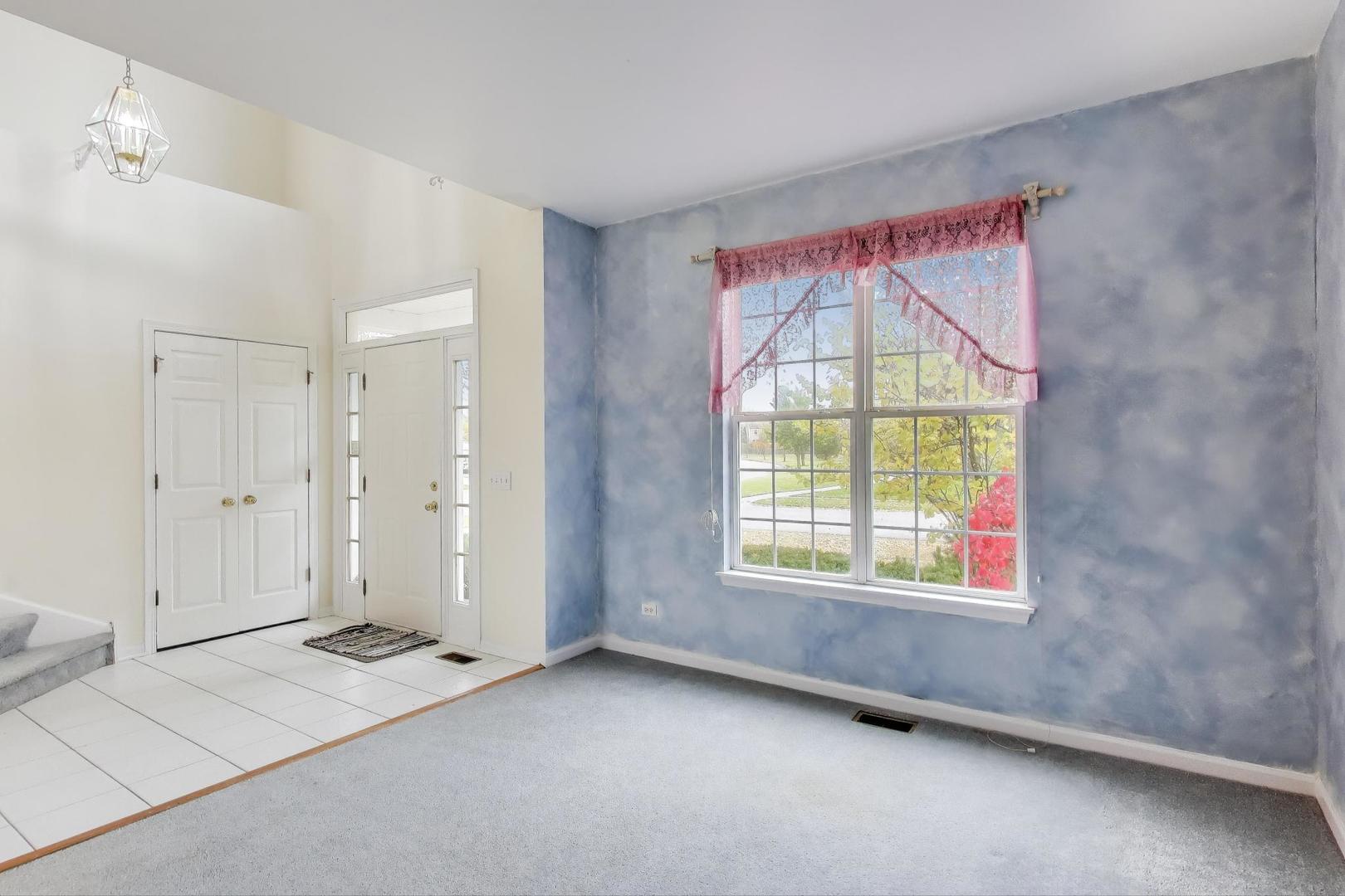 697 Providence Lane Lindenhurst, IL 60046 - Photo 5 of 31 a view of an empty room with a window