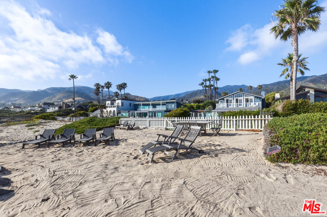 30810 Broad Beach Road Malibu, CA 90265 - Photo 55 of 55 a view of a swimming pool with a bench and lawn chairs
