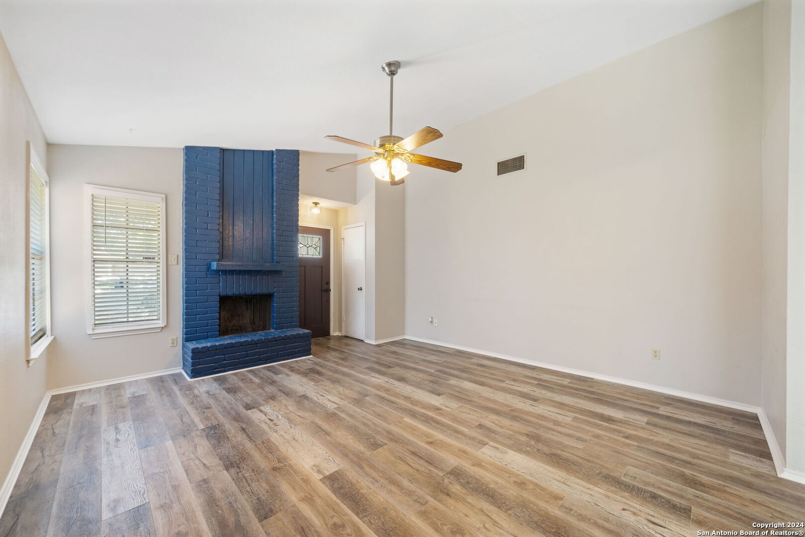 12106 Ridge Ct Street San Antonio, TX 78247 - Photo 11 of 25 a view of an empty room with a fireplace and a window